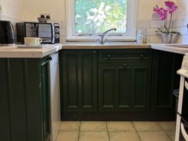 A kitchen with cabinets and a sink at 2 Bed Barn Barroway Drove near Downham Market