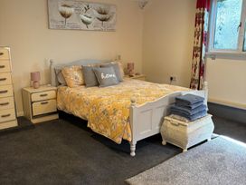 A bedroom with a bed and bedside table at 2 Bed Barn Barroway Drove near Downham Market