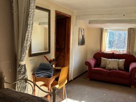 A living room with a sofa and table at 2 Bed Barn Barroway Drove near Downham Market