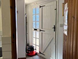 An entrance hall with a door and a vacuum cleaner at 2 Bed Barn Barroway Drove near Downham Market