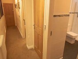 A hallway with doors and a toilet visible at 2nd Floor Apartment in Llandudno