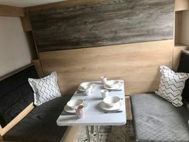 A dining area with a table set for meals at Inverness Lodge in Inverness