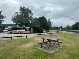 A food truck and picnic table near a river at Inverness Lodge in Inverness