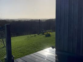 An outdoor area with grass and flowers at Shepherds hut Dumfries