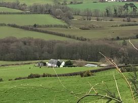 A house and garden in a rural landscape at Shepherds hut Dumfries
