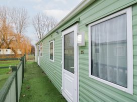 An outdoor area with a mobile home and grassy surroundings at No 35 MP Billing Aquadrome Holiday Park