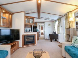 A living room with a television and sofa at No 35 MP Billing Aquadrome Holiday Park