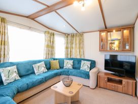 A living room with a sofa and TV at No 35 MP Billing Aquadrome Holiday Park