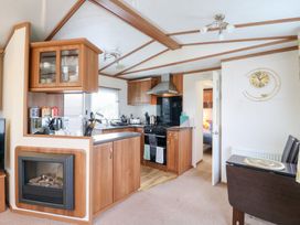 A kitchen with cabinets and stove at No 35 MP Billing Aquadrome Holiday Park