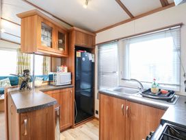 A kitchen with cabinets and appliances at No 35 MP Billing Aquadrome Holiday Park