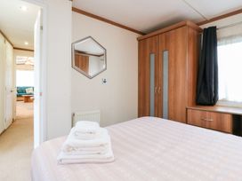 A bedroom with a bed and wardrobe at No 35 MP Billing Aquadrome Holiday Park
