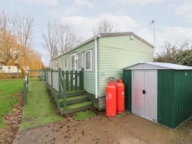 A mobile home with steps and a storage shed at No 35 MP Billing Aquadrome Holiday Park
