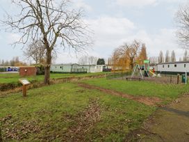 An outdoor area with a playground and caravans at No 35 MP Billing Aquadrome Holiday Park