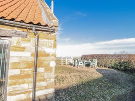 An outdoor area with a table and chairs at Millstone cottage in Whitby