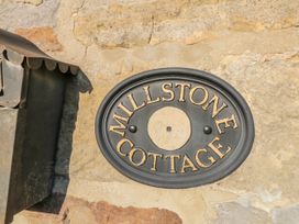 A nameplate on a stone wall at Millstone cottage in Whitby