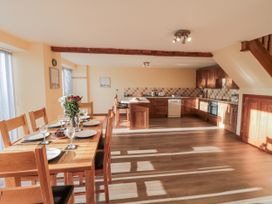 A kitchen with a dining table and chairs at Millstone Cottage Sneaton Thorpe near Whitby