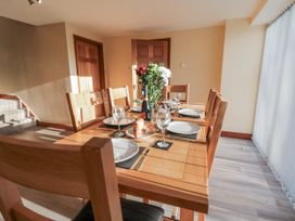 A dining room with a table and chairs at Millstone Cottage Sneaton Thorpe near Whitby