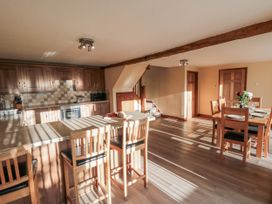 A kitchen with an island and dining table at Millstone Cottage Sneaton Thorpe near Whitby