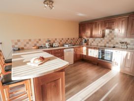 A kitchen with countertops and appliances at Millstone Cottage in Sneaton Thorpe near Whitby