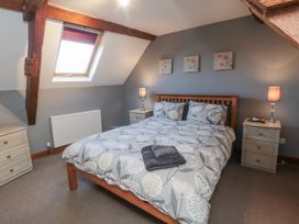 A bedroom with a double bed and bedside tables at Millstone Cottage Sneaton Thorpe near Whitby
