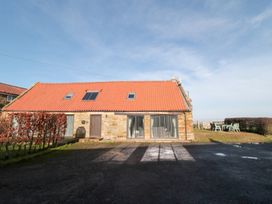A house with windows and a door at Millstone Cottage Sneaton Thorpe near Whitby