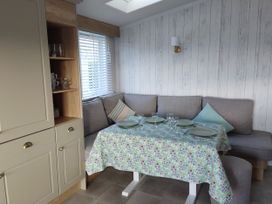A dining area with a table set for meals at Harbour View in Poole