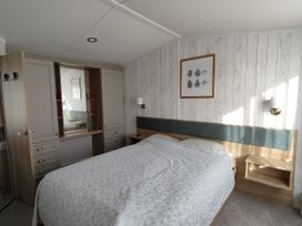 A bedroom with a bed and wardrobe at Harbour View in Poole