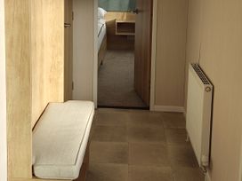 A hallway with a bench and radiator at Harbour View in Poole