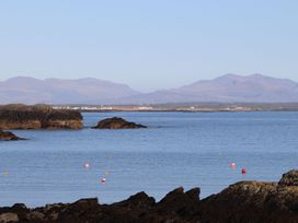 A coastal view with rocks and buoys at Bodior Garden Cottage Bach Holyhead