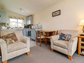A kitchen with a dining table and chairs at Sea Breeze in Welcombe near Morwenstow
