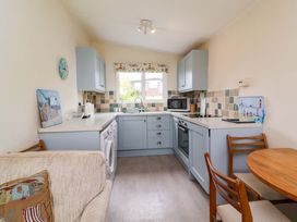 A kitchen with cabinets and appliances at Sea Breeze near Morwenstow