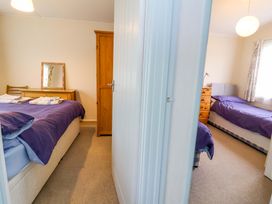 A bedroom with beds and furniture at Sea Breeze in Welcombe near Morwenstow
