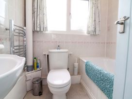A bathroom with a toilet, bathtub, and sink at Sea Breeze in Welcombe near Morwenstow