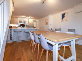A dining room with a table and chairs at Poldreth in Truro