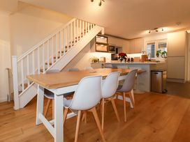 A kitchen with a dining table and chairs at Poldreth in Truro