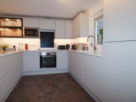 A kitchen with modern appliances and storage at Poldreth in Truro