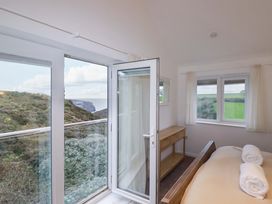 A bedroom with a bed and a table at Poldreth in Truro