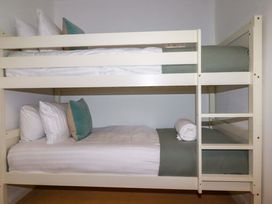 A bunk bed with pillows and a towel at Poldreth in Truro