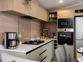 A kitchen with cabinets and appliances at Arlington 40 x 14 Three Bed in Northwich