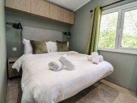 A bedroom with a bed, pillows, and a window at No.6 - The Pines Delamere