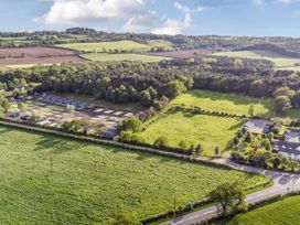 An aerial view showing fields and parking near caravans at The Pines 3 Bedrooms Delamere