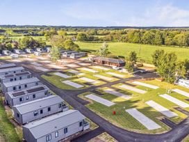 A park with caravans and parking spaces at The Pines 3 Bedrooms Delamere
