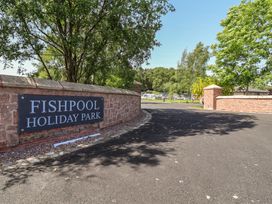 A sign for Fishpool Holiday Park at the entrance of the road