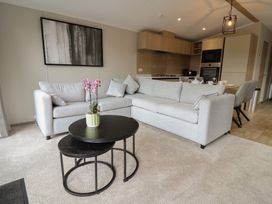 A living room with a sofa and coffee table at The Pines 3 Bedrooms in Delamere