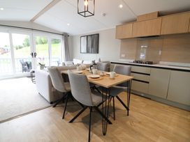 A dining area with a table and chairs at The Pines 3 Bedrooms in Delamere