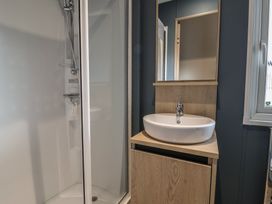 A bathroom with a shower and a sink at The Pines 3 Bedrooms Delamere