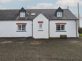 A cottage with windows and a driveway at Rhosgranog Cottage Llandeloy near Solva