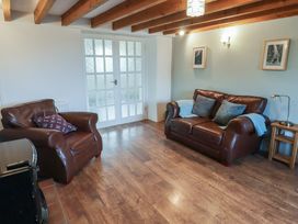A living room with sofas and a coffee table at Rhosgranog Cottage Llandeloy near Solva