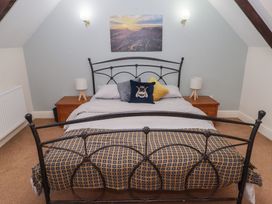 A bedroom with a bed and nightstands at Rhosgranog Cottage Llandeloy near Solva