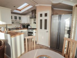 A kitchen with a refrigerator and oven at Rhosgranog Caravan in Llandeloy near Solva